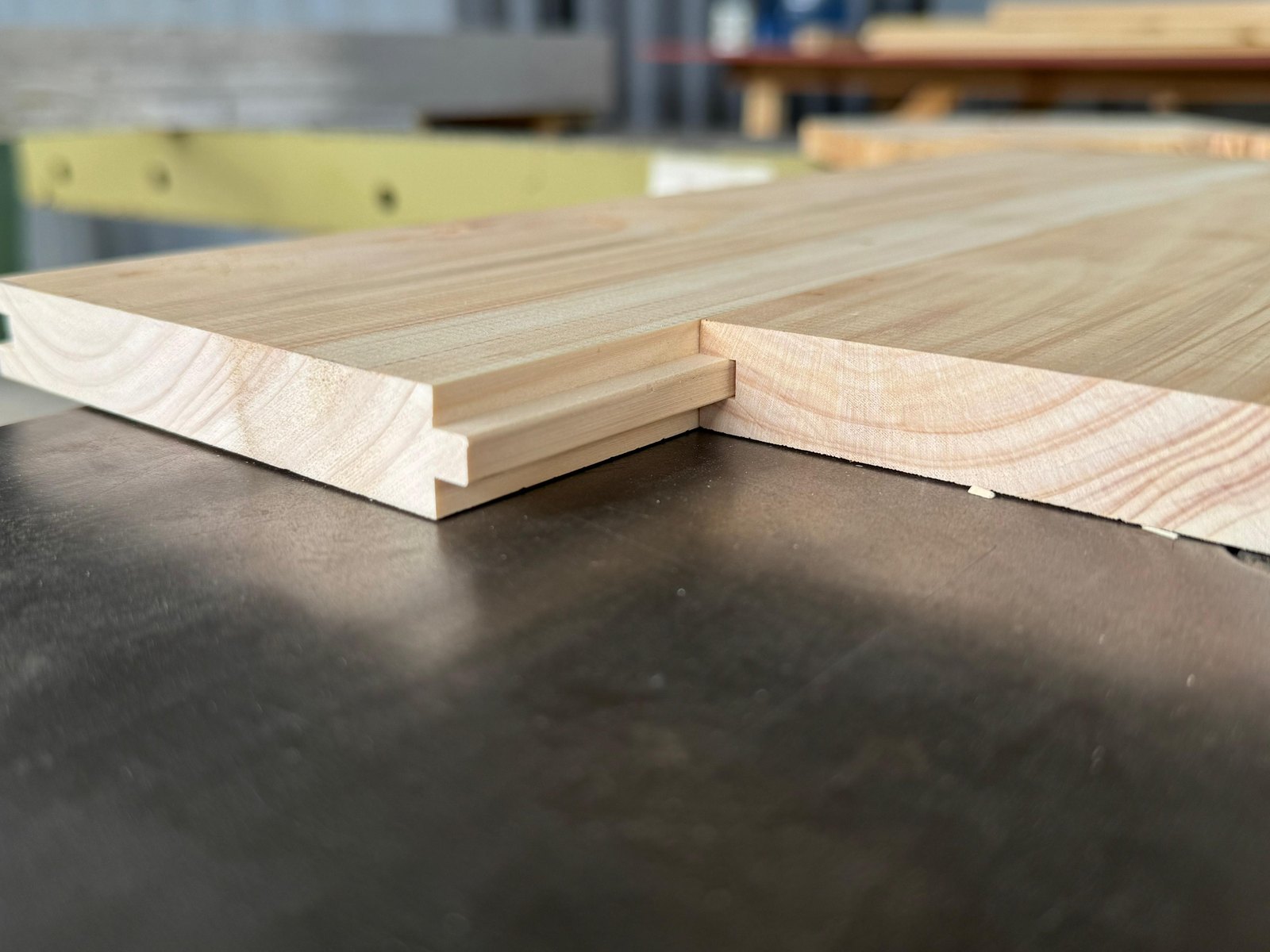 A tongue and groove board machined in the TimberStone workshop, showing the profile that lets each board move without opening a gap