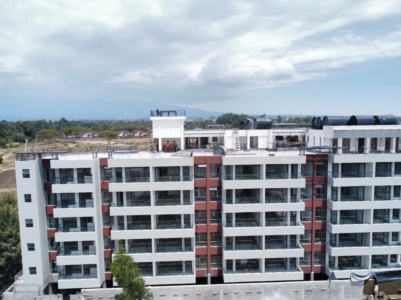 Front elevation of the Nanyuki apartment building showing glazed balconies, external finishes and rooftop water tanks.